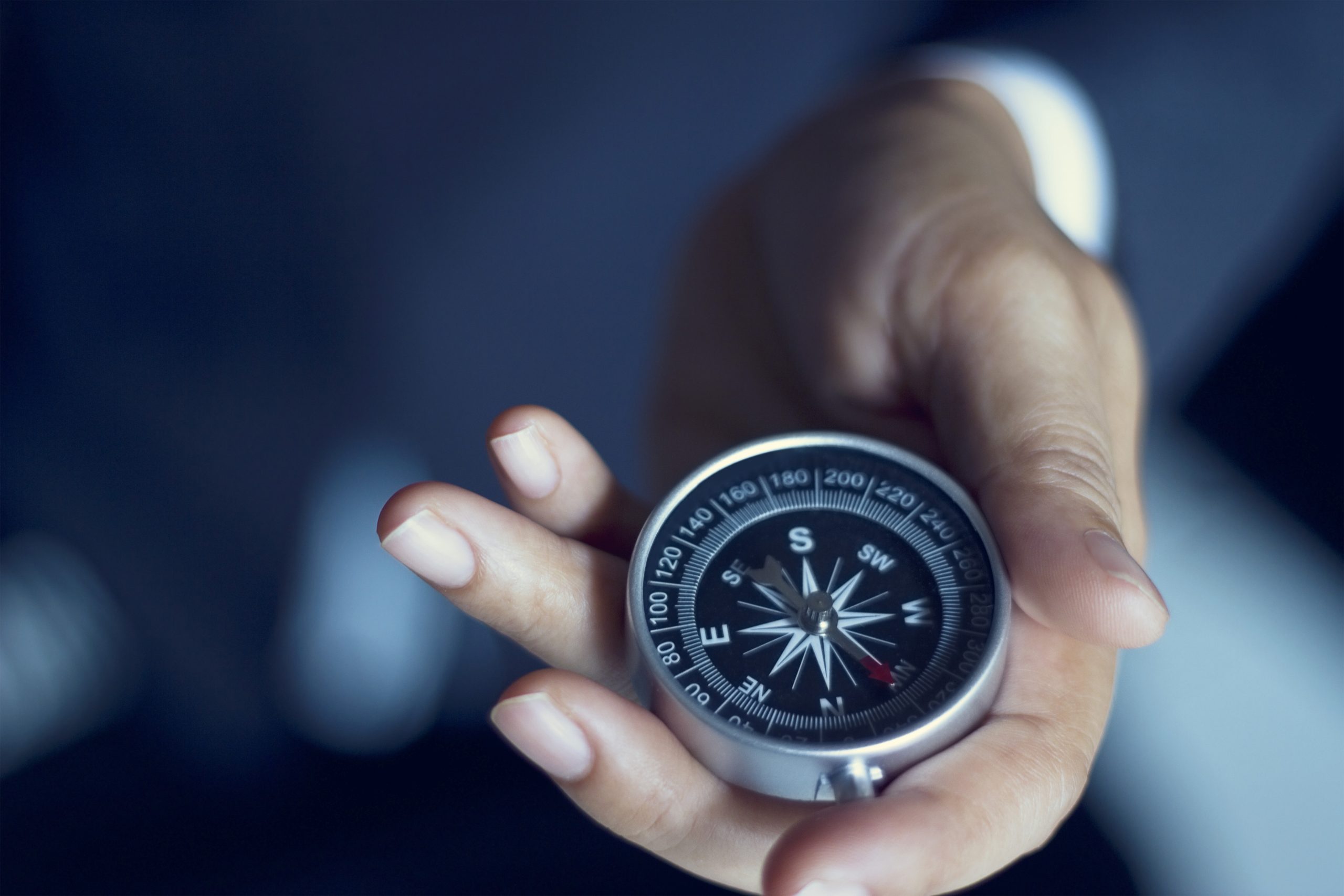 Fountain Consulting and Management We exist because we enjoy helping our clients grow and succeed Businessman With A Compass Holding In Hand, Color Tone Film Look